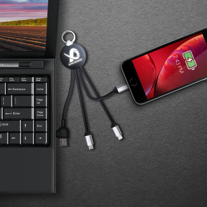 A black LED charge cable with multiple connectors attached to a laptop and smartphone, featuring a logo.