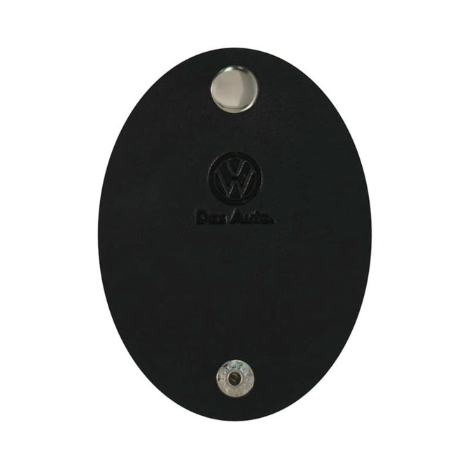 A black oval cable tidy with a metallic button and a logo. Suitable for managing cables and cords.