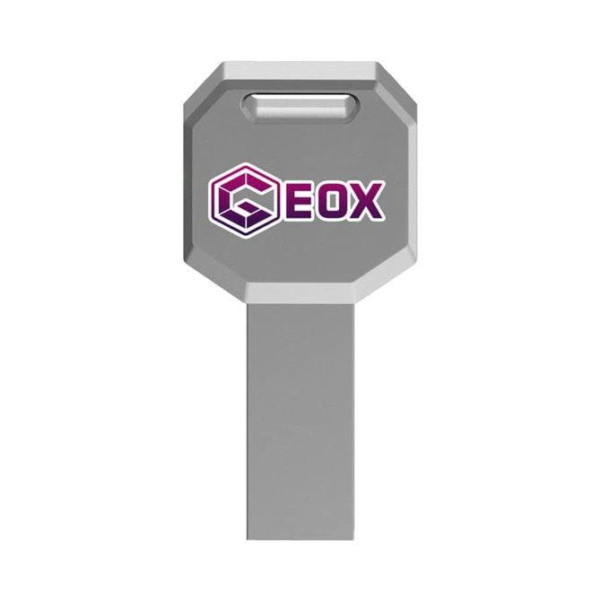 A grey octagonal USB flash drive with a branding logo on one side.