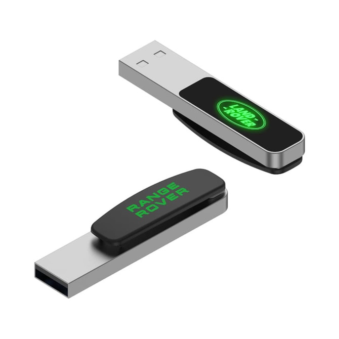 A silver and black LED flash drive features a logo on one side and a USB connector on the other side.