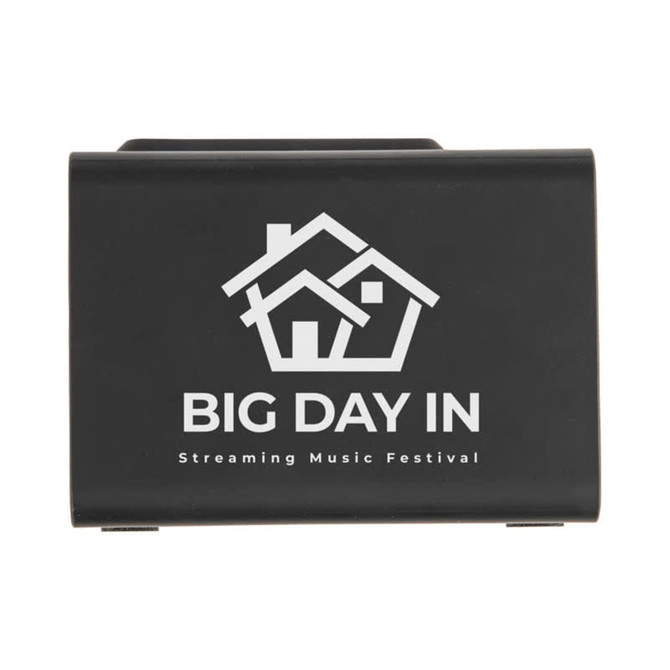 A black wireless charger with speaker features a house logo and promotional text for a music festival.