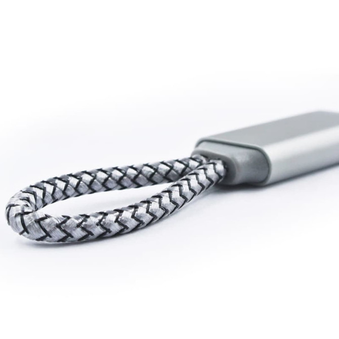 A grey and black braided charging cable with a flat connector, featuring a small logo on the body.