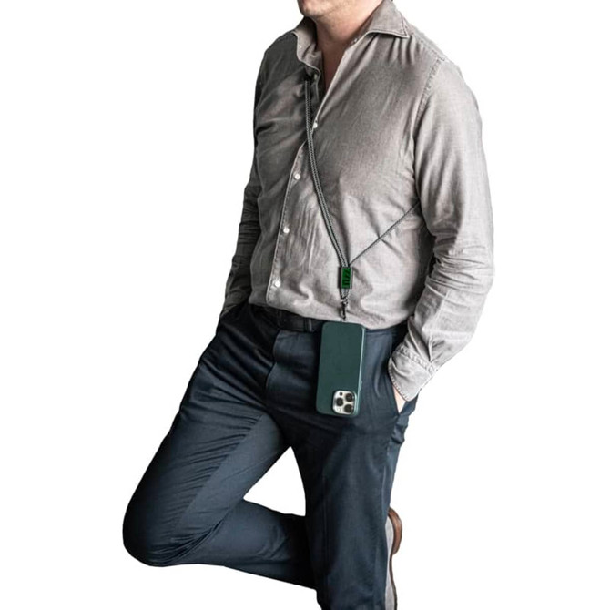A green crossbody phone strap attached to a phone, worn by a person in a light grey shirt and dark trousers.