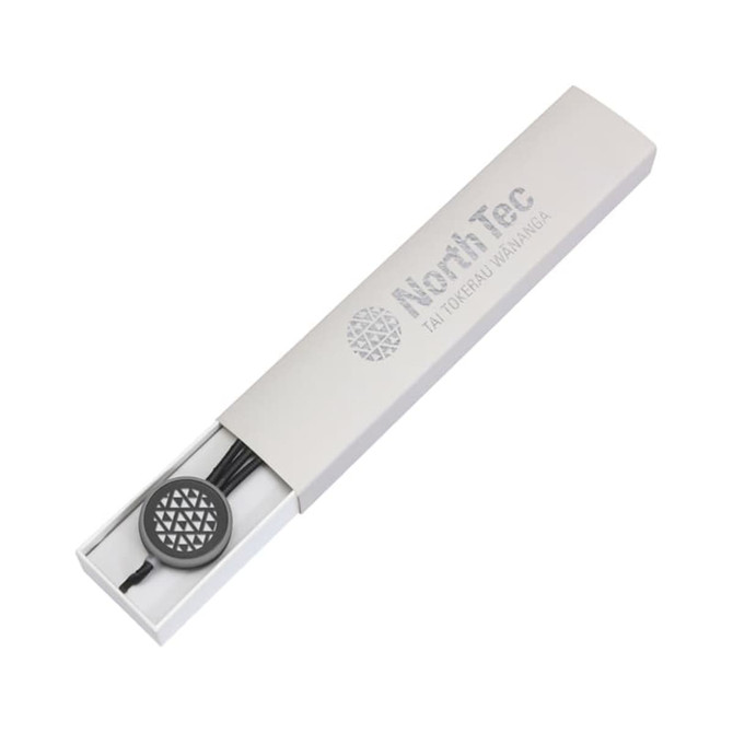A sleek white gift box containing a pen, featuring a branded logo and a decorative closure.