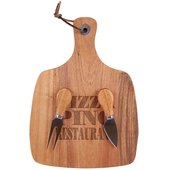 A wooden acacia cheese board in a paddle shape with two cheese knives, featuring a leather hanging loop.
