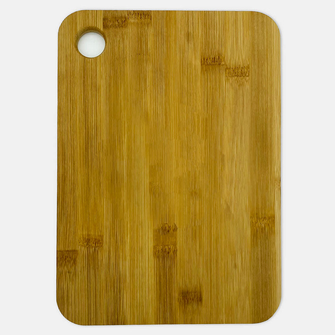 A large bamboo cutting board with a round hole in one corner, featuring a natural light brown finish.