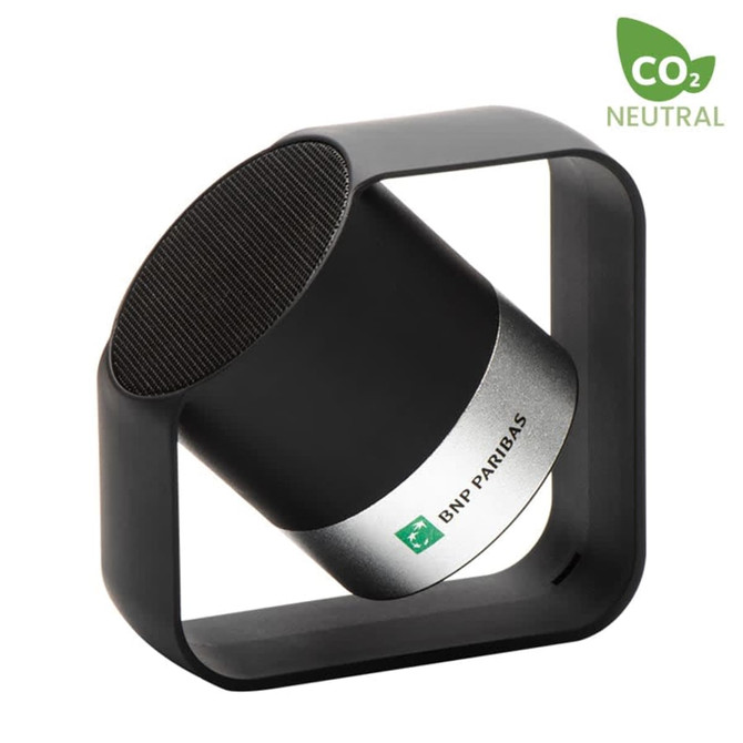 A black and silver wireless speaker within a square frame, featuring a logo.
