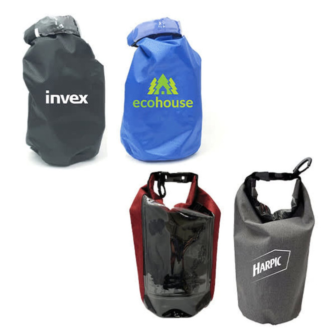 Four dry bags in different colours: black, blue, burgundy, and grey, each featuring a logo.