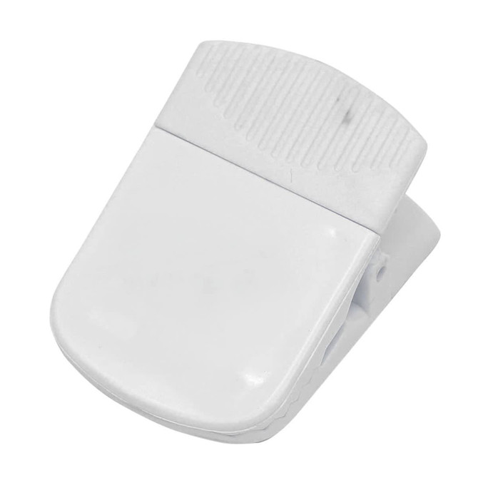 A white magnetic clip designed for holding papers or items securely, featuring a textured grip area.