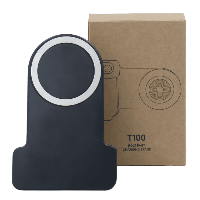 A wireless charger in black with a silver accent, positioned in front of its cardboard packaging.