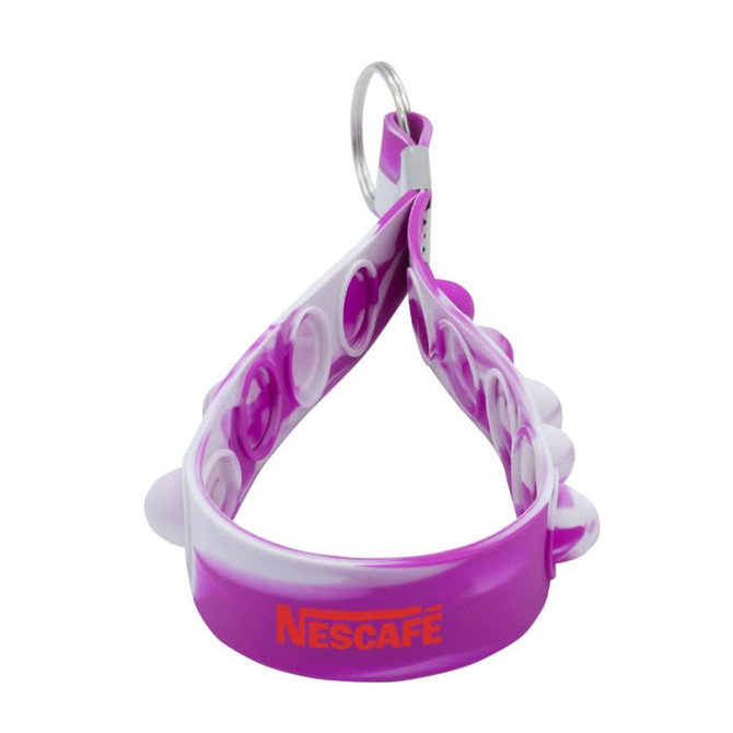 A purple and white Popper Stress Reliever Key Chain with a circular design and a metal keyring.