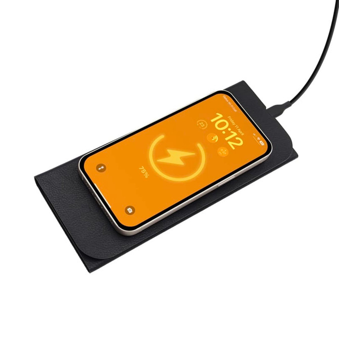 A wireless charging mouse pad in black with a smartphone displaying a charging indicator on top.