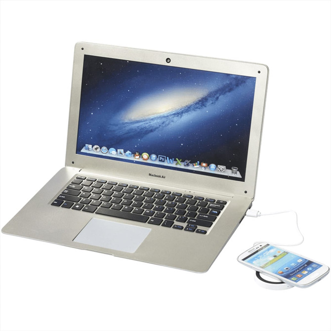 A wireless charging pad in white and solid black, with a laptop and smartphone positioned nearby.