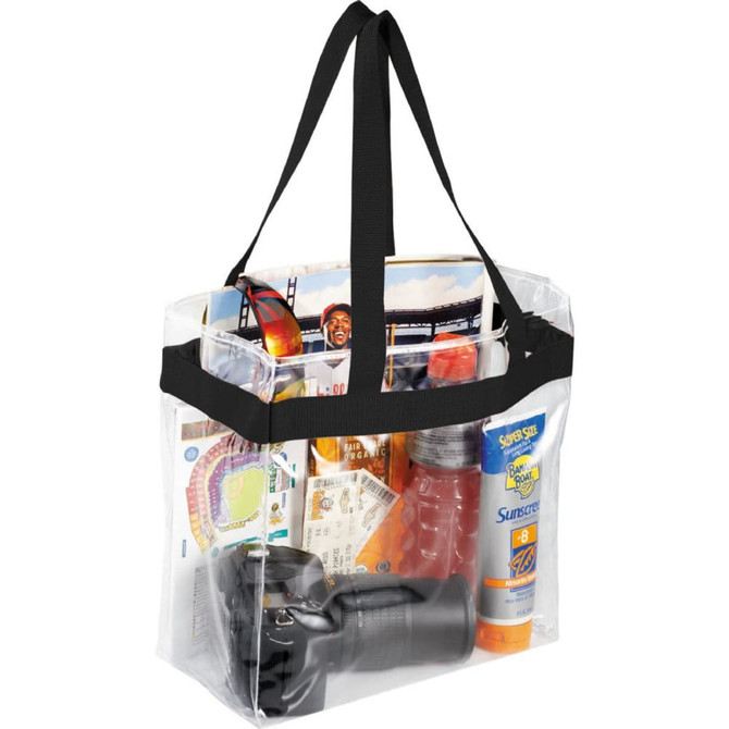 A clear stadium tote bag filled with a camera, sunscreen, drinks, tickets, and magazines, featuring black handles.