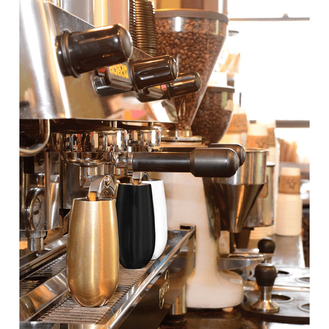 A drink bottle duo featuring a gold and a black vacuum champagne flute, situated on a café espresso machine.