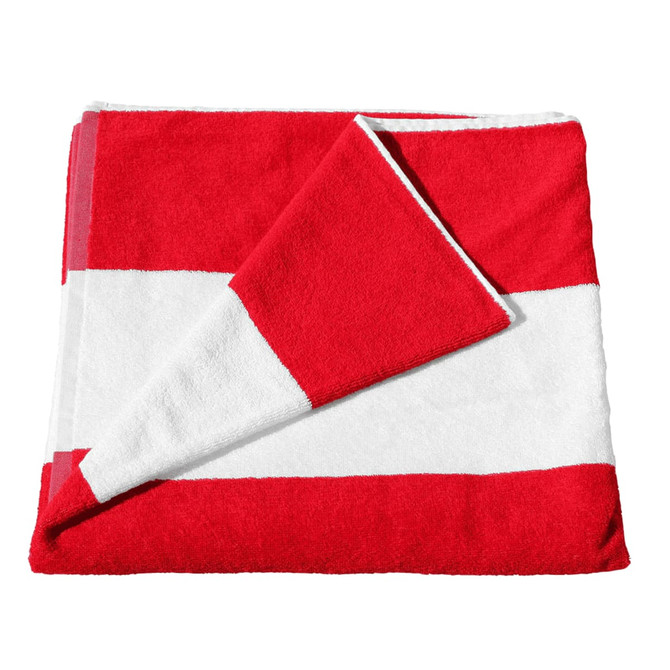A red and white striped cotton beach towel, neatly folded with one corner slightly turned down. It has a logo.