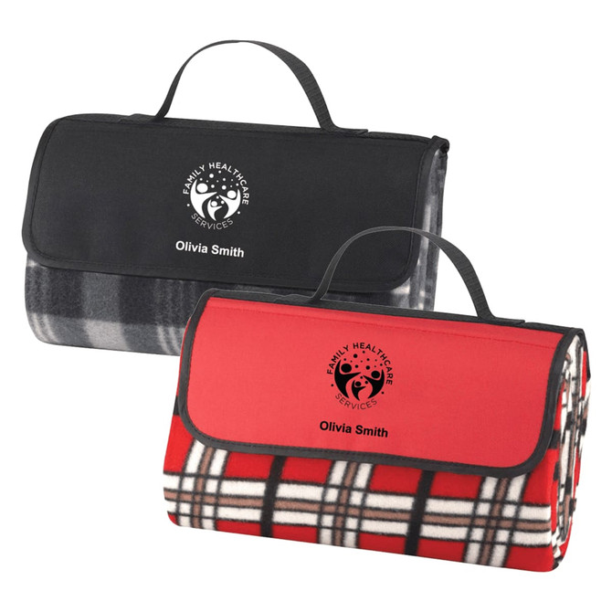 Two folded picnic rugs, one in black and grey checkered pattern, the other in red and black checkered pattern, featuring branding.