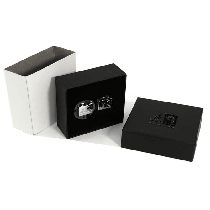 A black gift box containing plain silver cufflinks, presented alongside a white box.