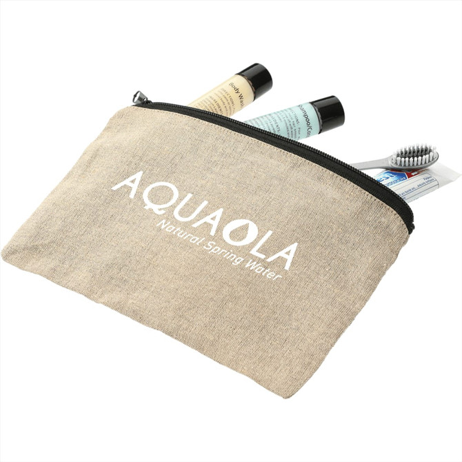 A beige recycled cotton twill pouch containing toiletries like tubes and a toothbrush, featuring a logo.