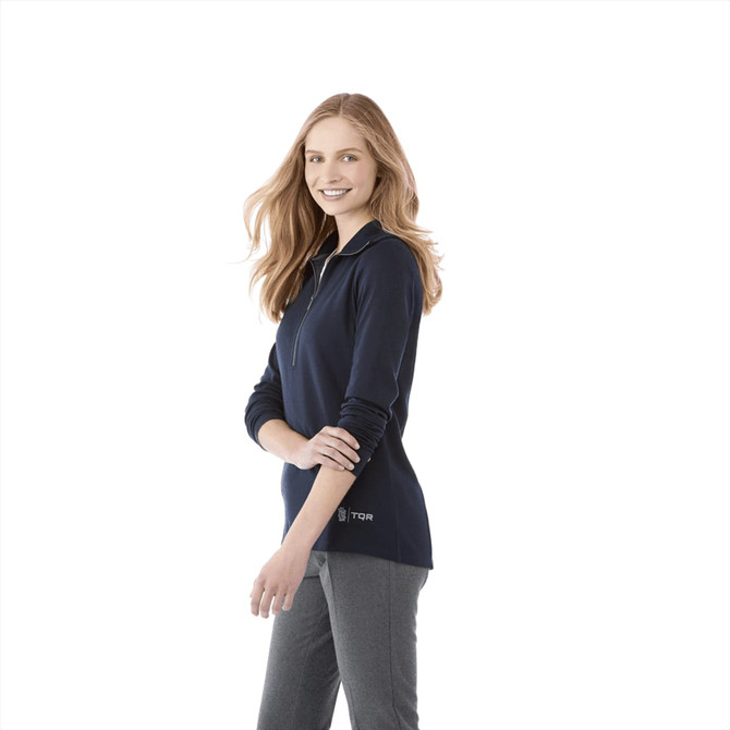A woman wearing a navy knitted half-zip jumper. The jumper features long sleeves and a logo.