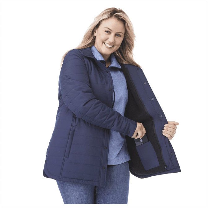 A navy insulated shacket with a zippered pocket, showcased by a smiling woman. It has a collar and buttons.