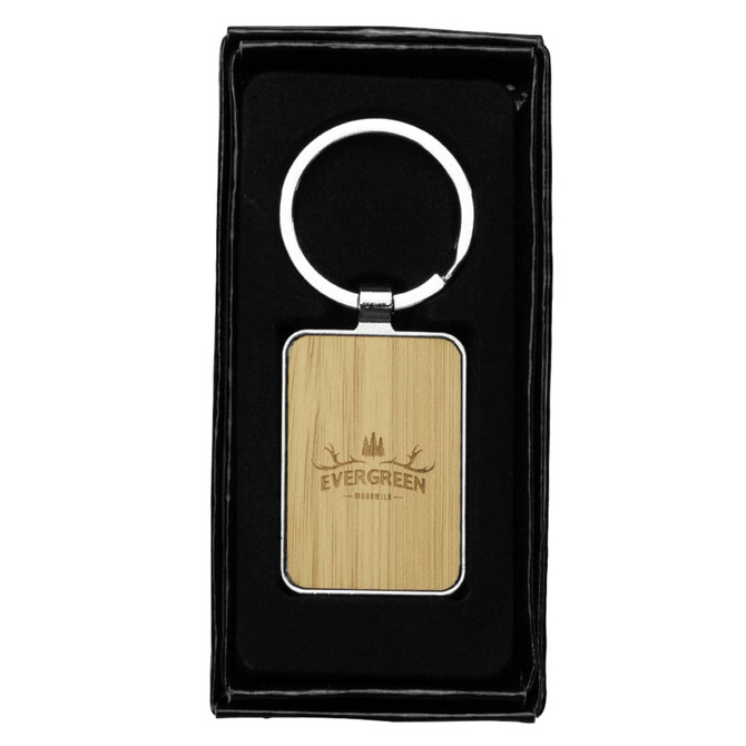 A rectangular keyring with a bamboo surface and a zinc alloy silver ring, presented in a black gift box.