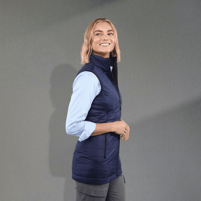 A lightweight, packable insulated puffer vest in navy blue, featuring a high collar and zippered pockets.