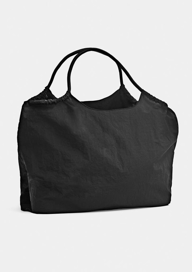 A black nylon tote bag with two handles and a soft, crinkled texture. It has a simple design and includes a logo.