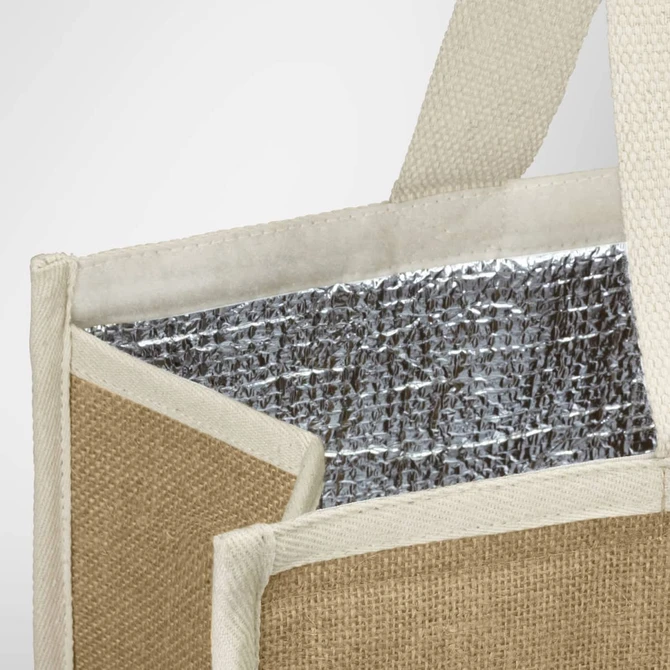 A jute cooler bag featuring a silver insulated interior and natural jute exterior with cream handles.