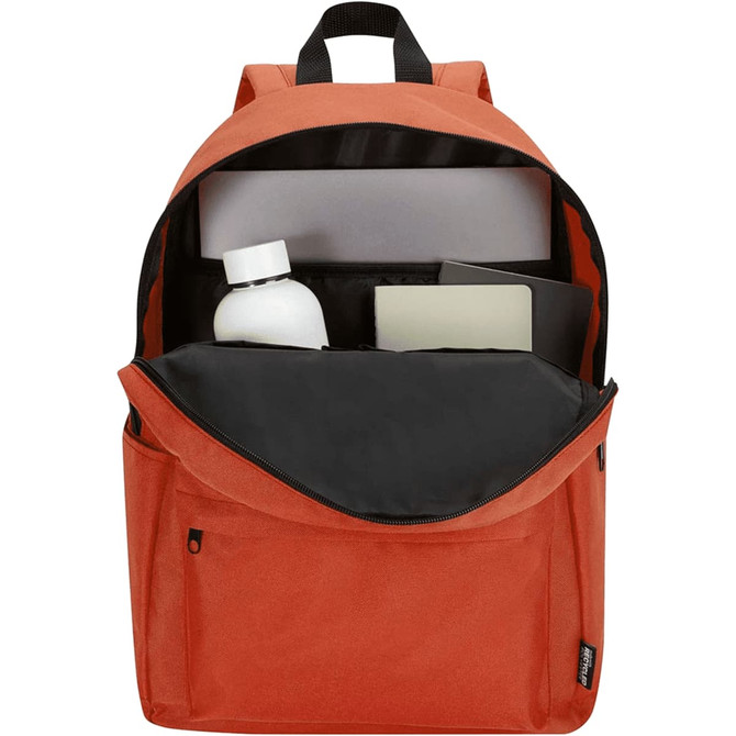 An orange laptop backpack with a spacious interior, containing a drink bottle, laptop sleeve, and notebook.