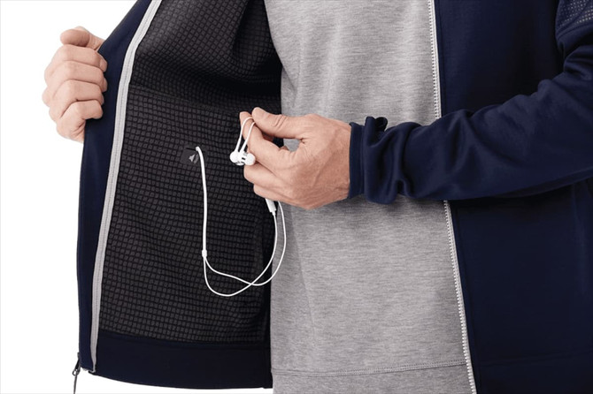 A navy performance jacket with a grey inner lining, featuring thumb holes and an earphone port inside.