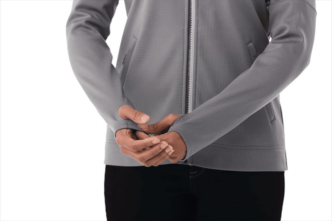 A lightweight grey full zip performance jacket featuring thumb holes, with a fitted silhouette and a branding logo.