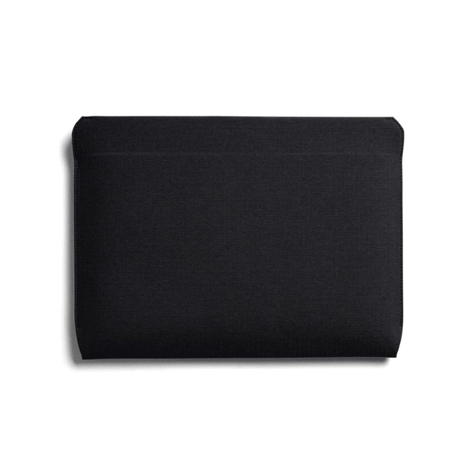 A black laptop sleeve with a smooth, minimalist design and a subtle logo. Suitable for 16-inch laptops.