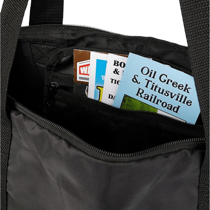 A black duffle bag interior with various pamphlets and brochures visible inside.