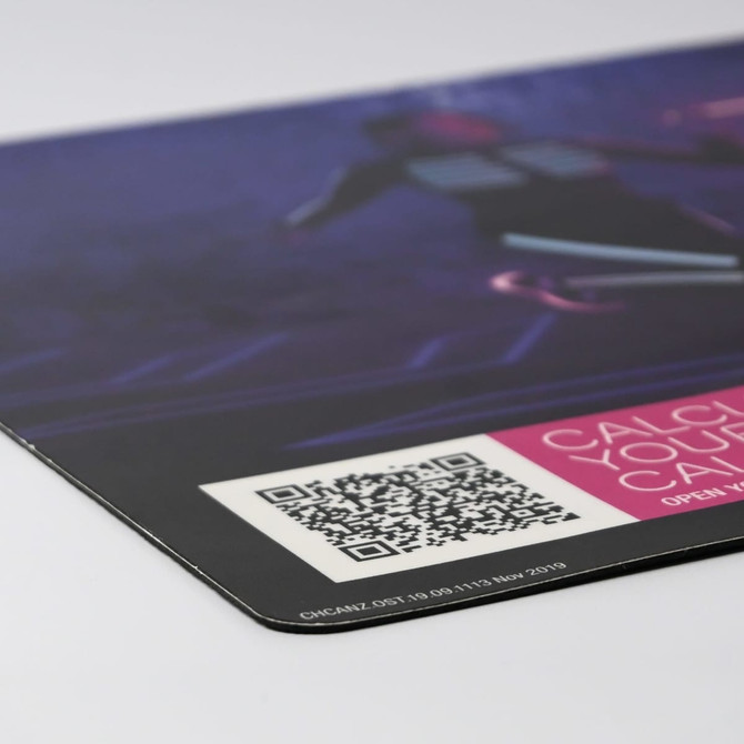 A counter mat featuring a vibrant design with shades of purple and black, displaying a QR code and a logo.