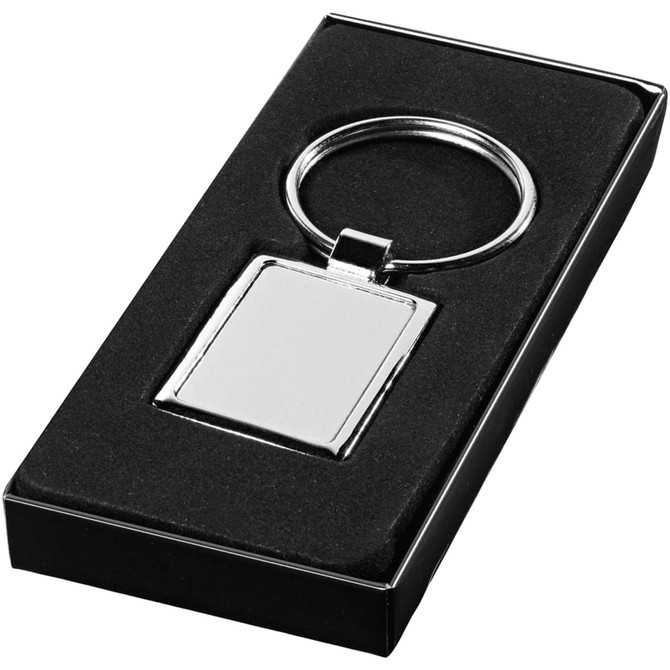 A rectangular silver keyring presented in a black gift box, featuring a blank surface for personalisation.