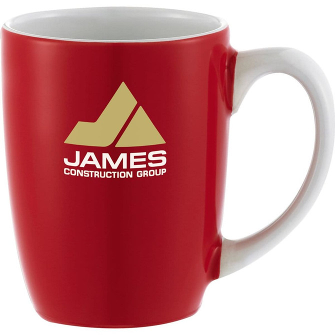 A red ceramic mug with a white handle, featuring a logo on the front. Holds 350ml.