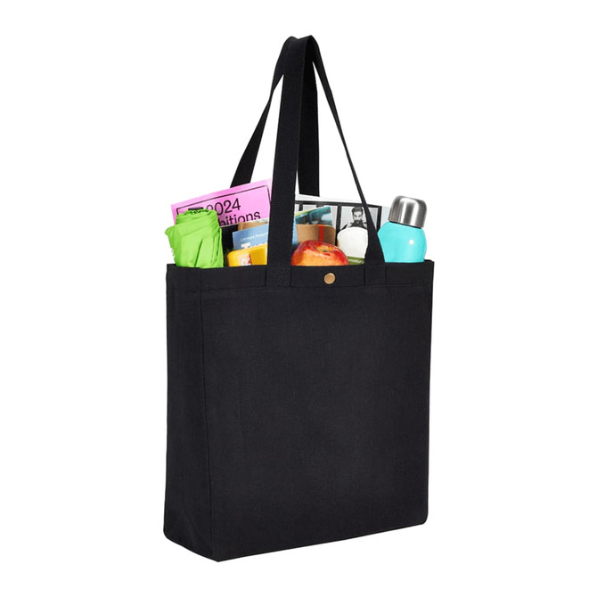 A black recycled cotton tote bag filled with various items, including bottles and papers, featuring a snap closure.