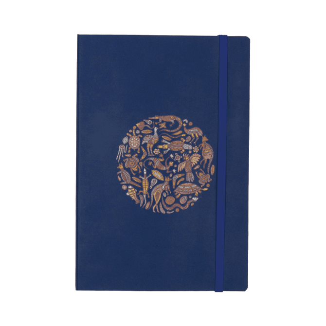 A navy blue soft bound journal featuring a decorative circle design and an elastic closure.