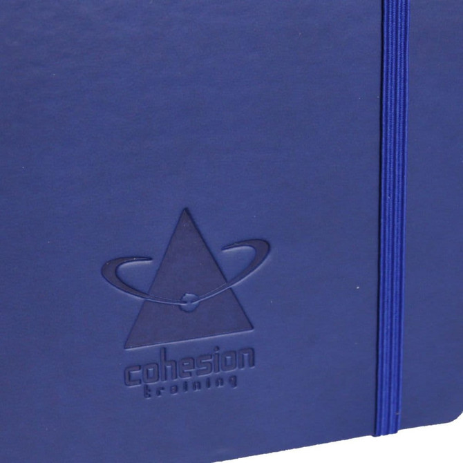 A blue soft bound journal featuring an embossed logo and an elastic band closure.