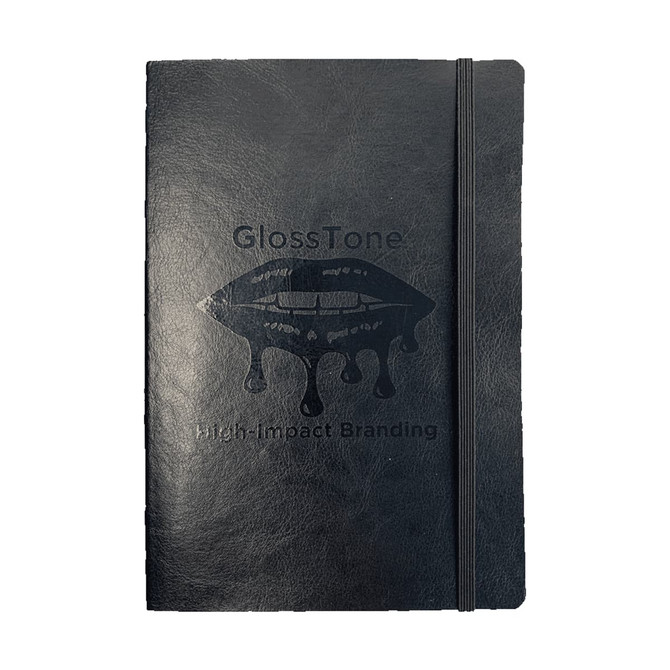 A black soft bound journal with an elastic closure and a logo printed on the cover.