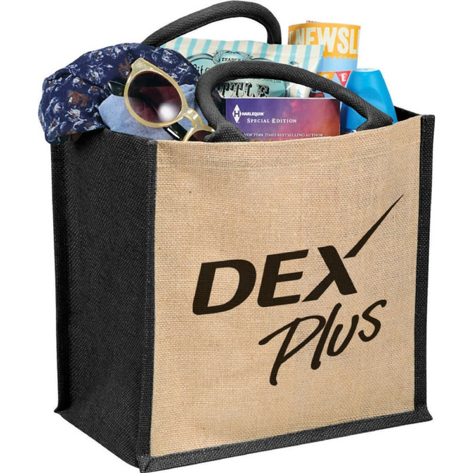 A medium jute gift tote in natural and black, filled with sunglasses, a scarf, and other items. Contains a logo.