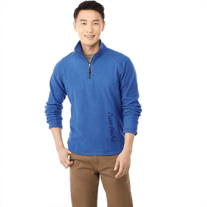 A blue polar fleece jumper featuring a quarter zip and a side logo, shown on a male model.