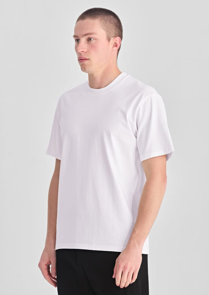 A white men's box tee displayed on a model, featuring a simple design and short sleeves.