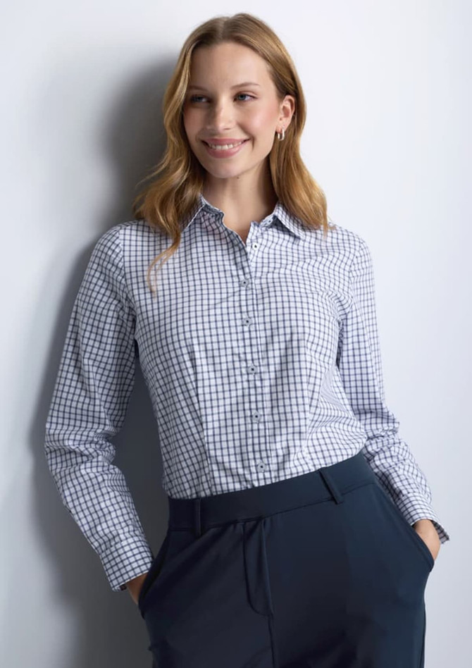 A long sleeve women's shirt in a blue and white check pattern, featuring a collar and a logo.
