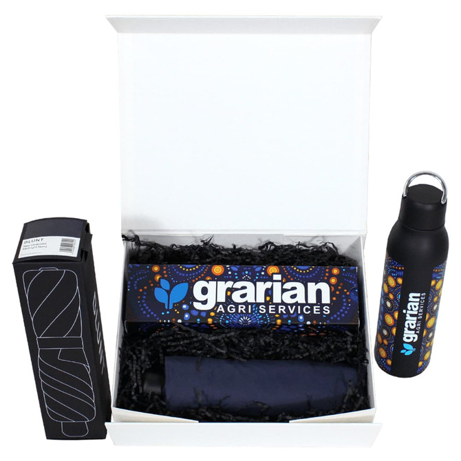 A gift box containing a black drink bottle and a branded item, surrounded by shredded paper. The box features a logo.