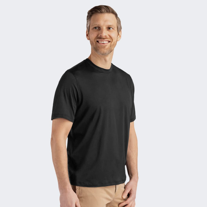 A man wearing a black short-sleeve tee in a relaxed fit, featuring a logo on the front.