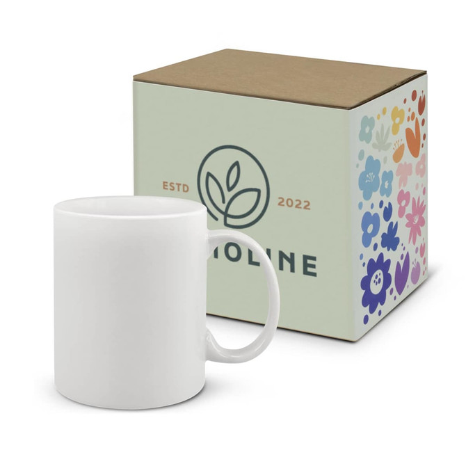 A white coffee mug sits alongside a patterned box featuring floral designs and a logo.