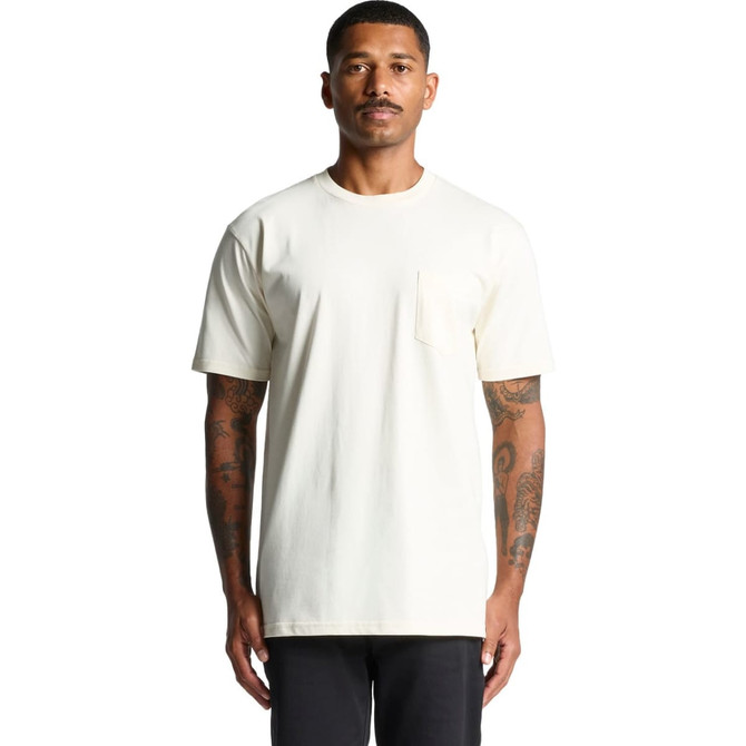 A light cream-coloured pocket t-shirt displayed on a model with tattoos, featuring a simple design and logo.