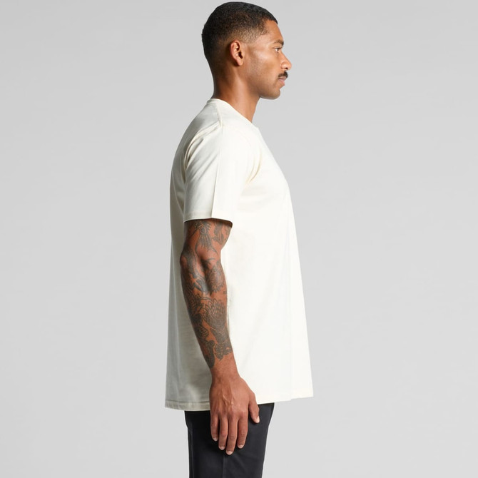 A plain cream Classic Pocket Tee displayed on a model from the side, featuring a logo on the chest.